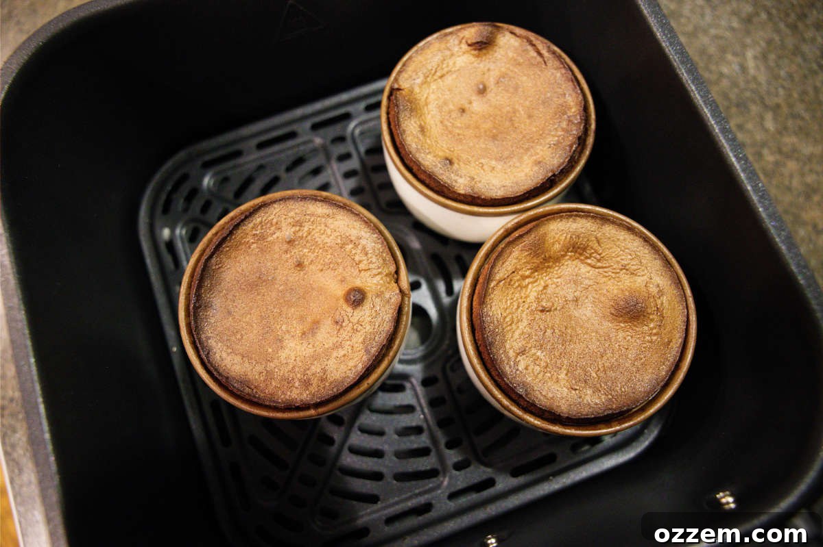 Chocolate mug cakes in air fryer basket.