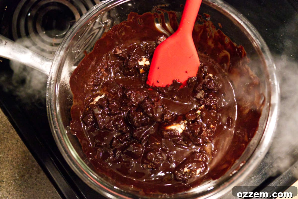 Melting chocolate in a bowl using a double boiler.