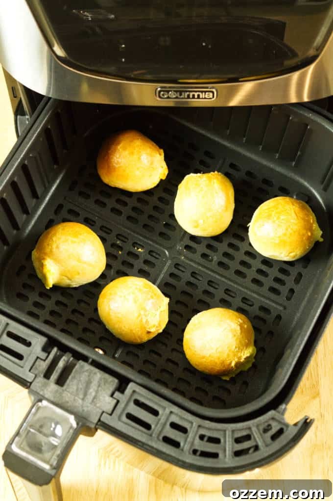 Air Fryer Mastery: Essential Tips and Tricks 6 Bagel bites perfectly spaced out in the air fryer basket, illustrating proper spacing for even cooking and crisping.