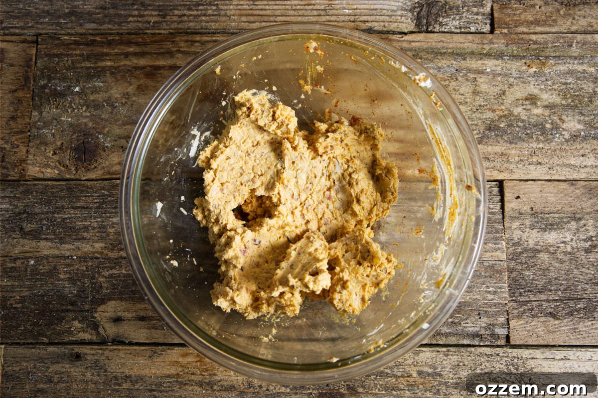 Cheese mixture in a glass bowl after being mixed