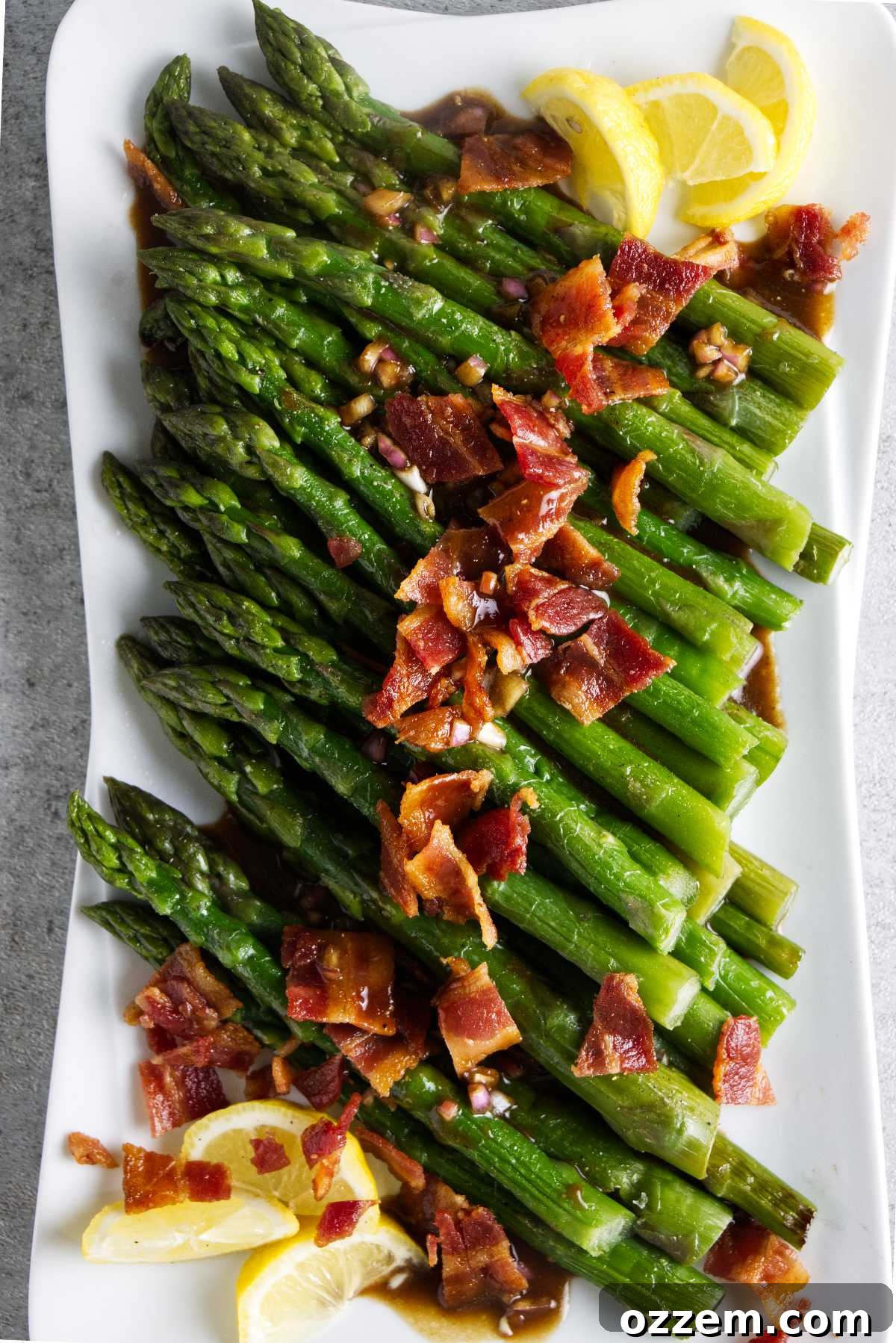 Crispy Air Fryer Frozen Asparagus 2 Frozen asparagus cooked in an air fryer and plated with lemon, bacon, and a dressing.