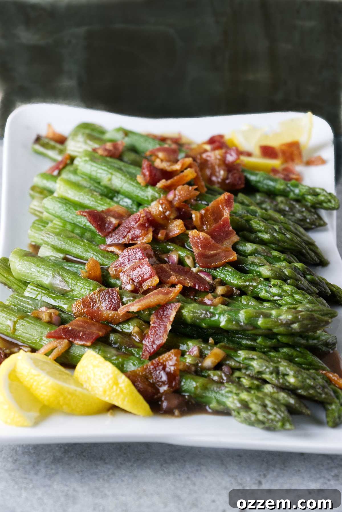 Crispy Air Fryer Frozen Asparagus 10 Asparagus cooked and plated with crumbled bacon, vinaigrette, and lemon wedges.