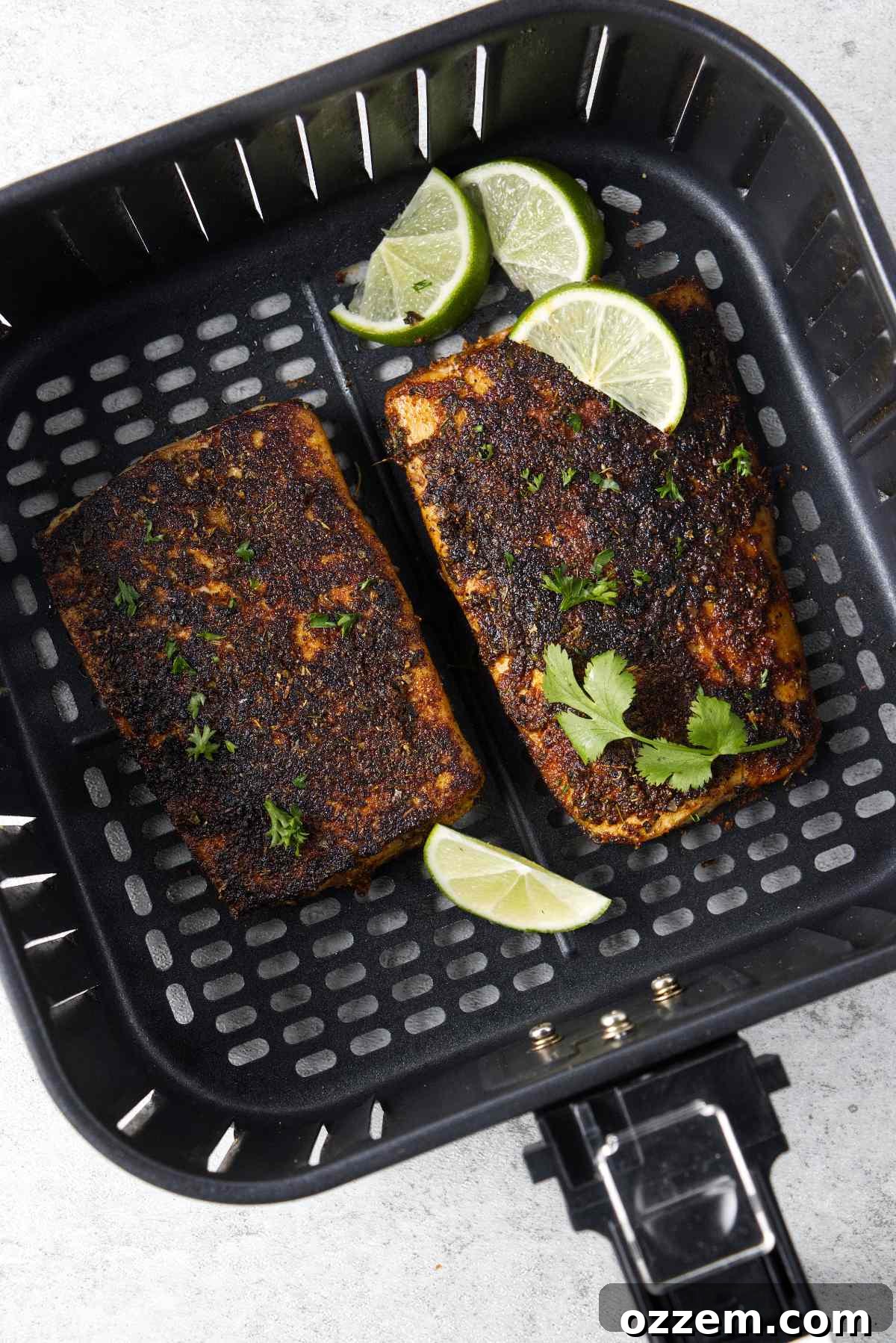 Golden Air Fryer Mahi Mahi 2 Two perfectly seasoned mahi mahi fillets resting in an air fryer basket, ready for cooking.