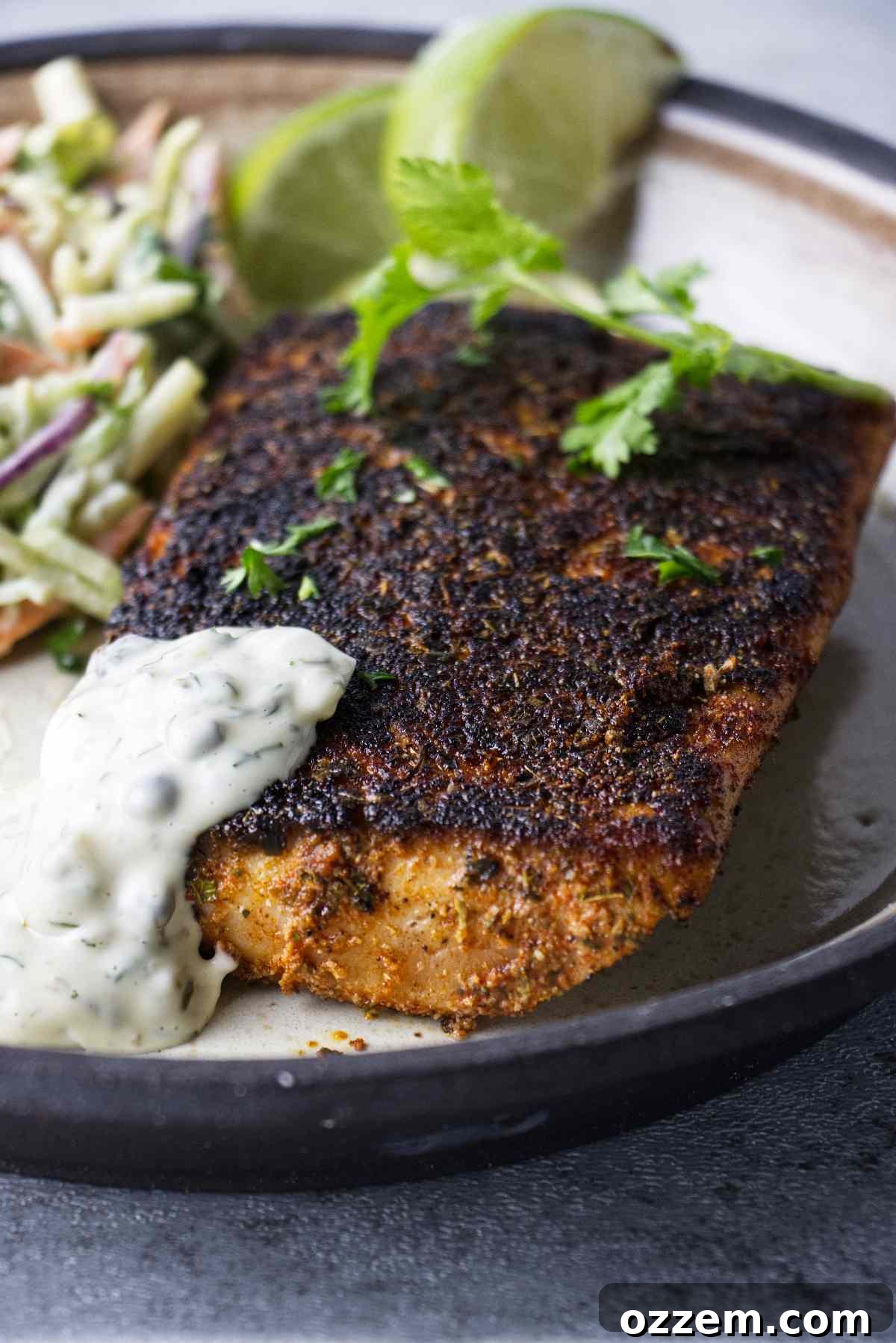 Golden Air Fryer Mahi Mahi 10 A stunning plate of air fryer blackened mahi mahi, garnished with fresh herbs and a generous serving of dill caper sauce.