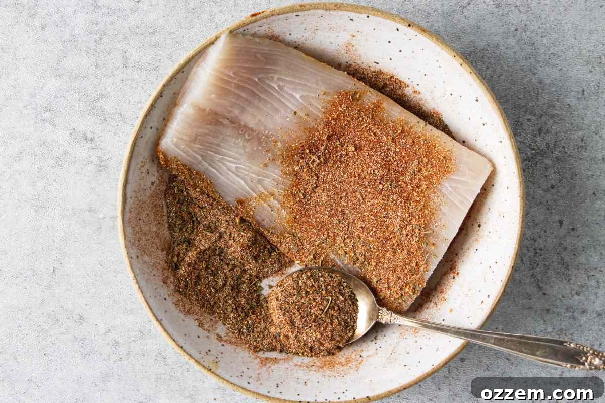 Golden Air Fryer Mahi Mahi 7 A mahi mahi fillet being generously coated with blackening seasoning, pressed for maximum flavor.