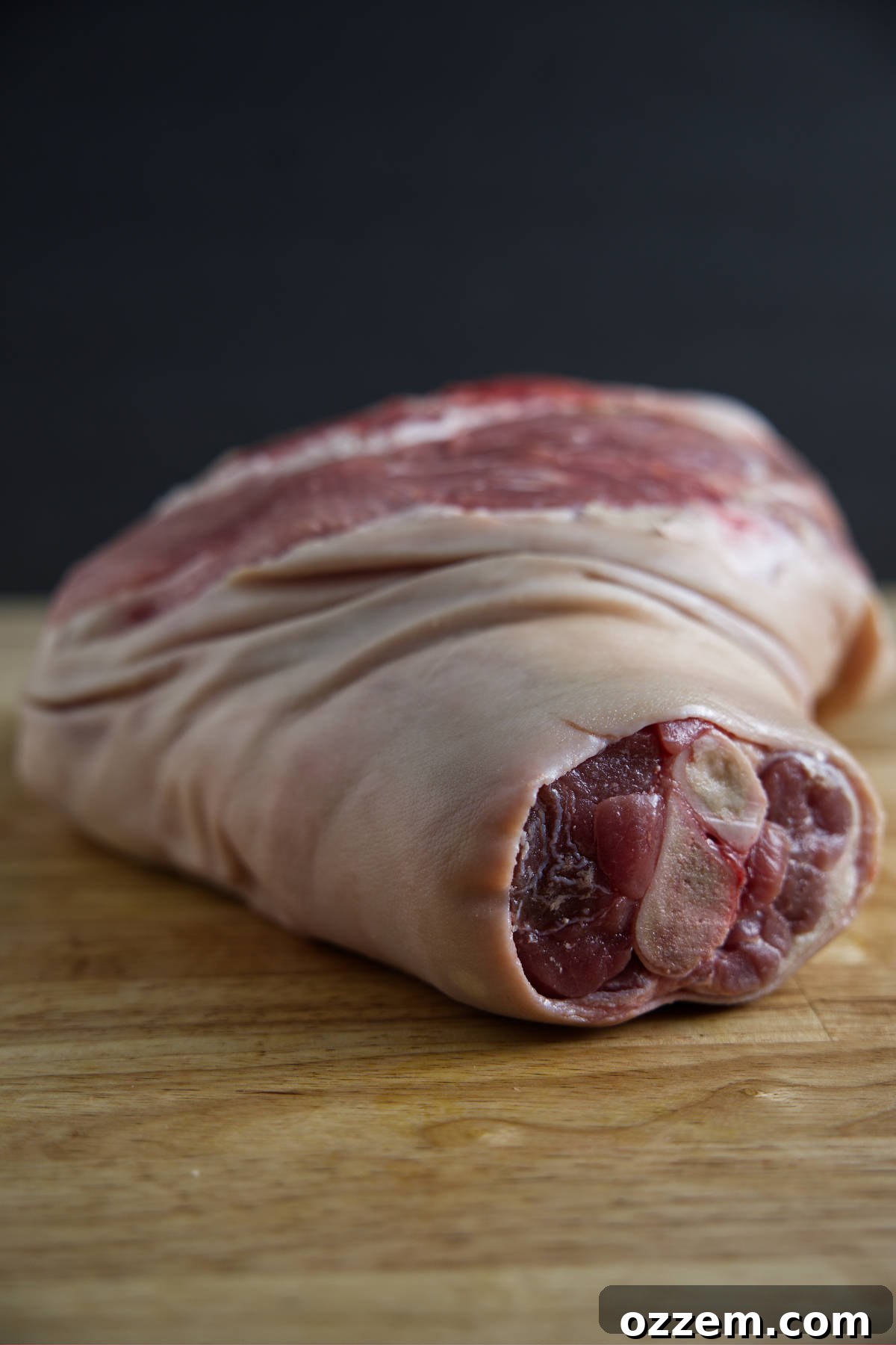 Picnic shoulder (pork shoulder) with skin on and bone in, showcasing its leaner profile.