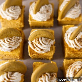 No bake pumpkin cheesecake bars with a gingersnap cookie on top, laid out in a grid.