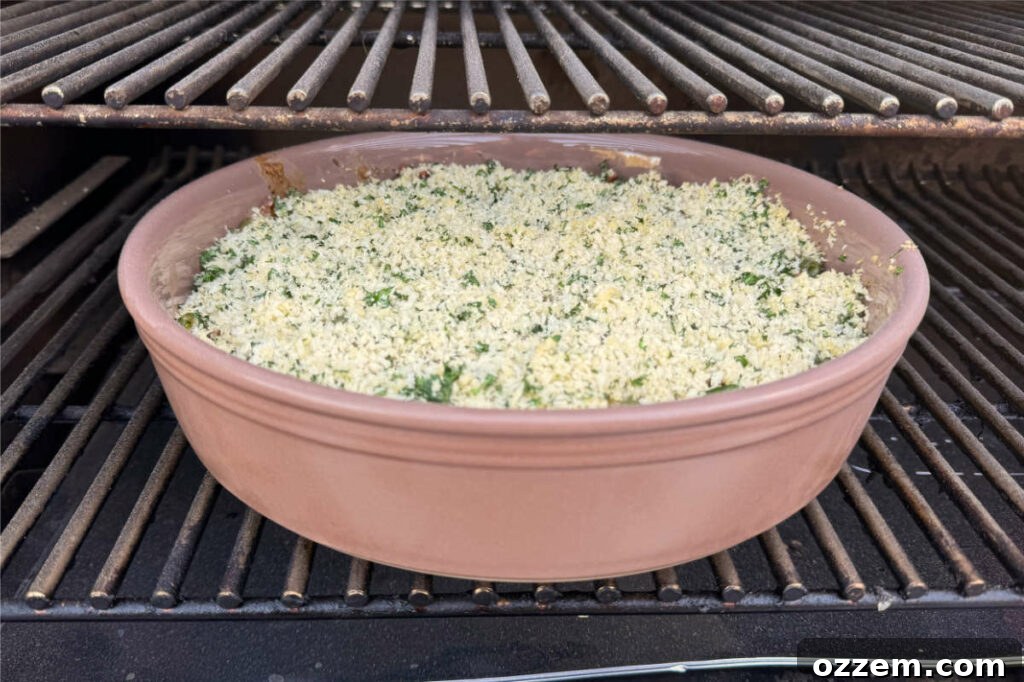 Smoked green bean casserole cooking inside a pellet grill smoker, with visible smoke around the edges.