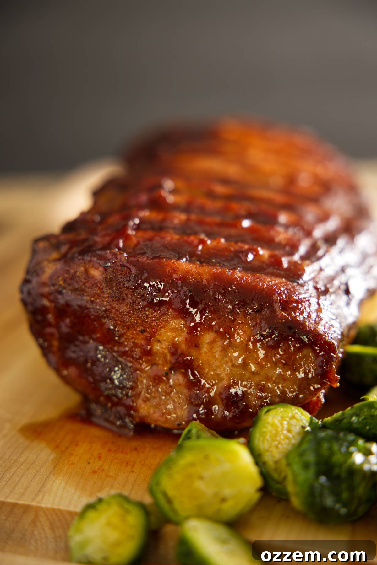Whole pork loin resting on cutting board.