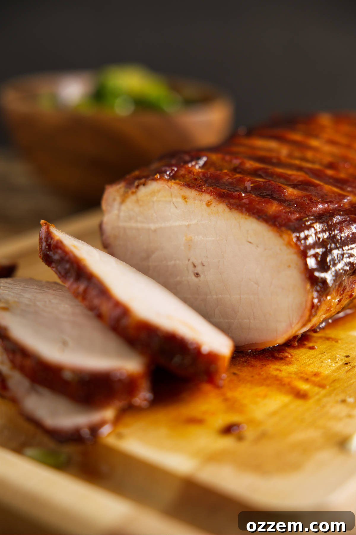 How to BBQ pork loin sliced and resting on cutting board.