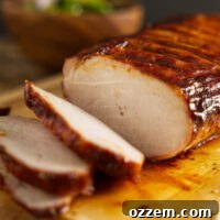 How to BBQ pork loin, whole pork loin sliced on cutting board.