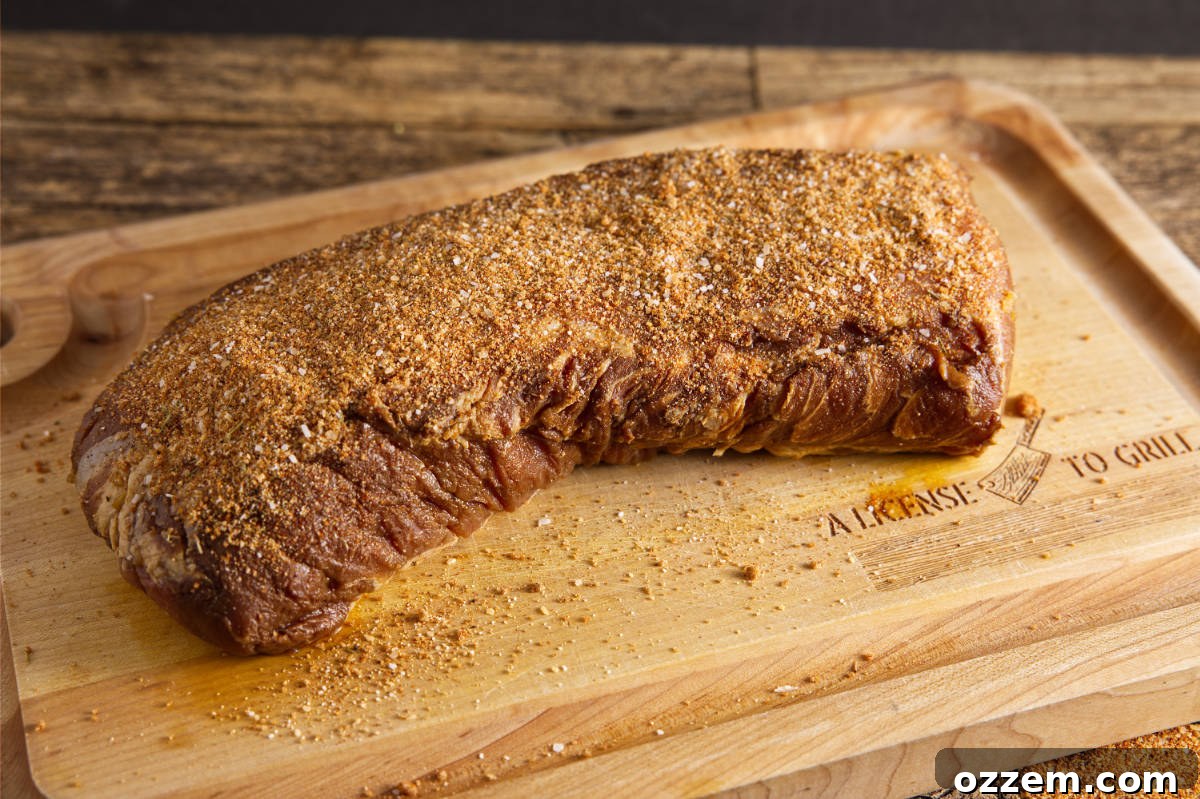 Putting dry rub on pork loin.