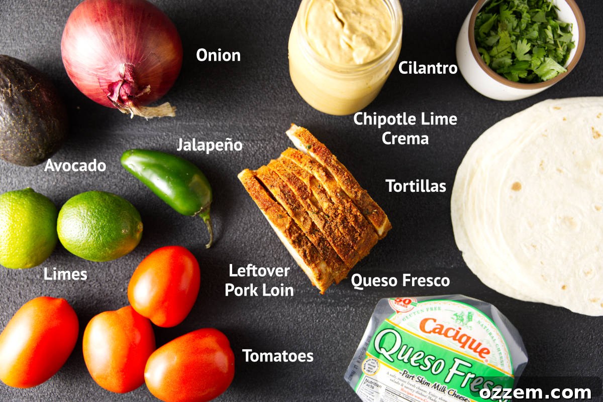 Pork Loin Taco Remix 3 A flat lay photograph showcasing all the fresh ingredients needed for irresistible leftover pork loin tacos, including diced smoked pork, vibrant avocado salsa components, a bowl of creamy chipotle lime crema, and crumbly queso fresco, all arranged appealingly for a culinary feature.