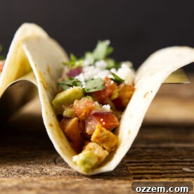 A perfectly assembled Leftover Pork Loin Taco, showcasing tender pork, fresh salsa, and creamy chipotle lime crema.