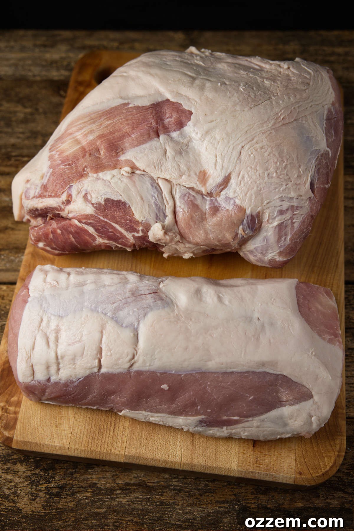 The Pork Loin Shoulder Showdown 3 Pork shoulder vs pork loin side-by-side laying on a butcher block.