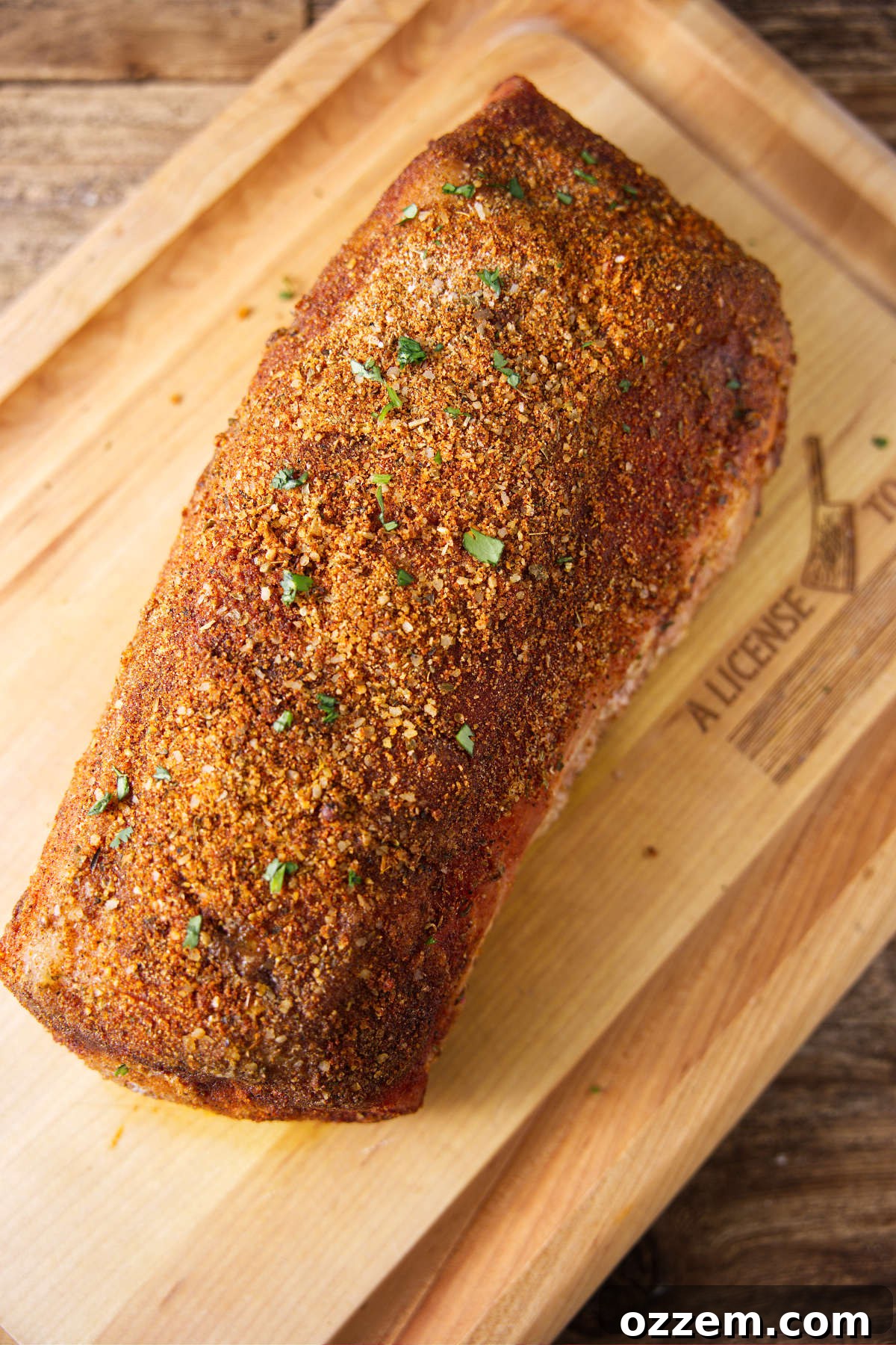 The Pork Loin Shoulder Showdown 5 Smoked pork loin resting on wood cutting board.