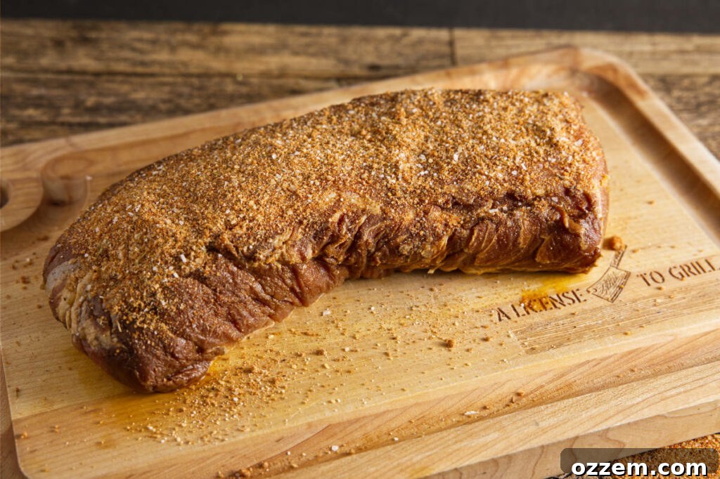Putting dry rub on pork loin.