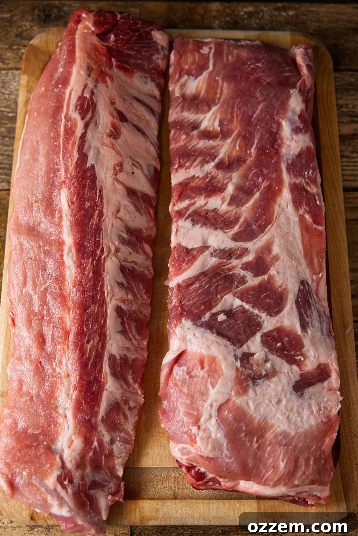 Pork Rib Perfection: Baby Back Ribs or St Louis Style? 5 Pork loin back ribs and st. louis style spare ribs on cutting board.