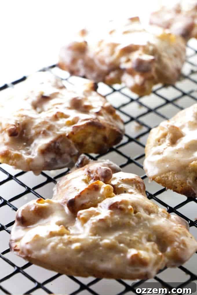 Fresh apple fritters on a cooling rack.