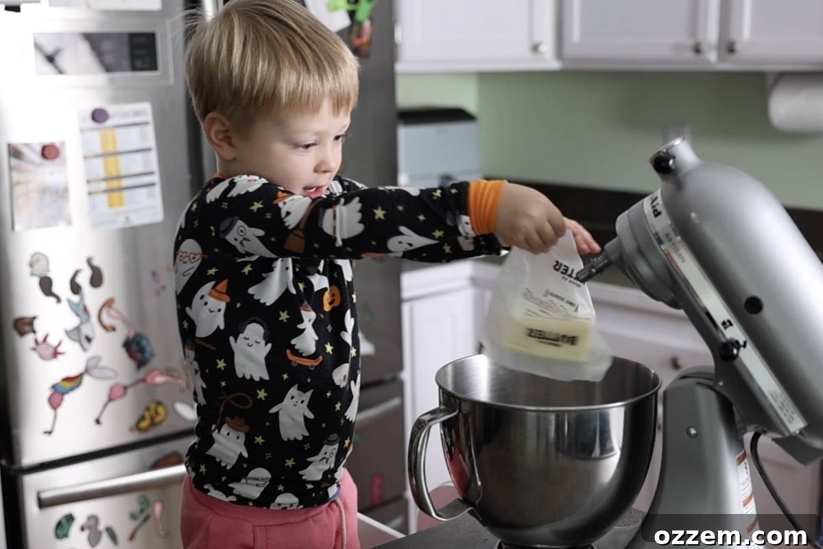 Adding a stick of butter to a stand mixer.