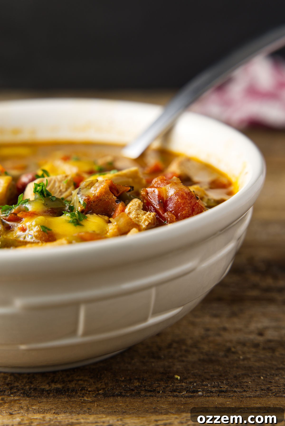 Smoky Leftover Turkey Chili 8 Bowl of leftover turkey chili with melted cheese and parsley on top.