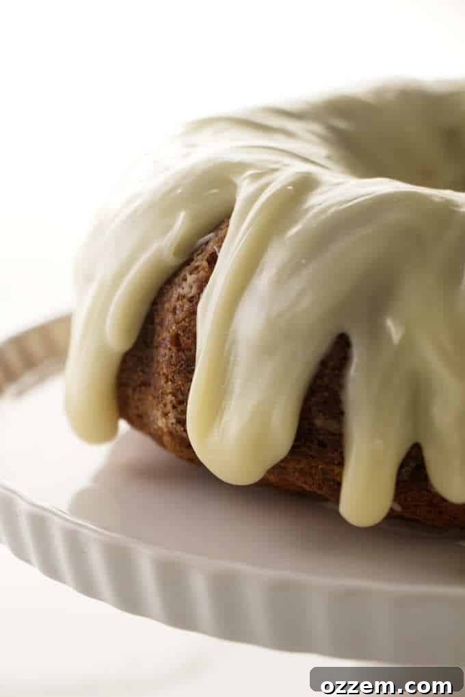 Golden Air Fried Banana Bundt 5 An elegantly frosted banana bundt cake with cream cheese icing, ready to be served.