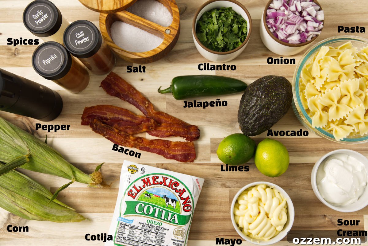 Mexican Street Corn Pasta Salad 3 Ingredients for the Mexican street corn pasta salad laid out on a butcher block countertop.