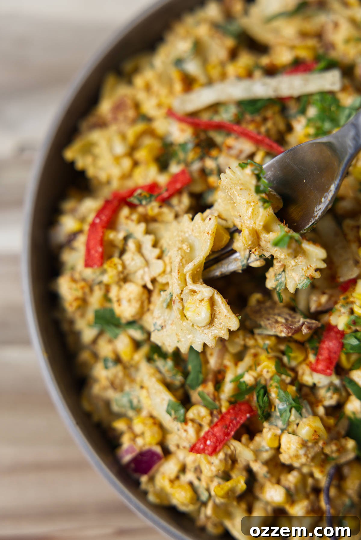 Mexican Street Corn Pasta Salad 10 Vibrant tortilla chips and tajin sprinkled on top of the street corn pasta salad.