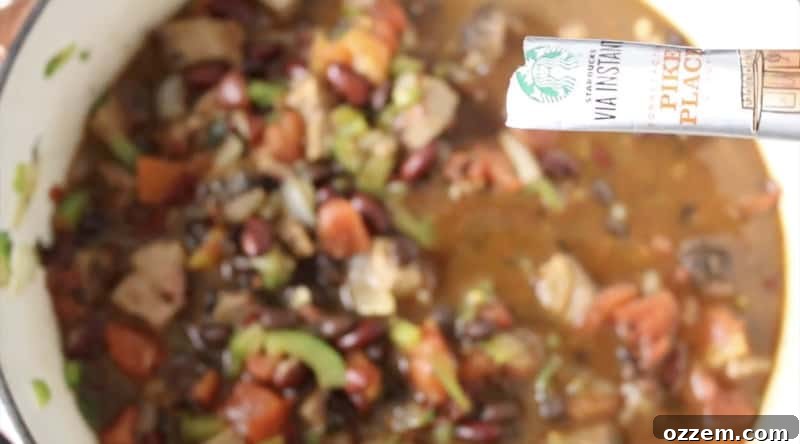 starbucks via instant coffee package being poured into smoked brisket chili