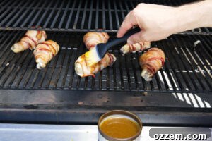 Smoky Traeger Stuffed Chicken Legs 16 Brushing stuffed chicken legs with a glaze.