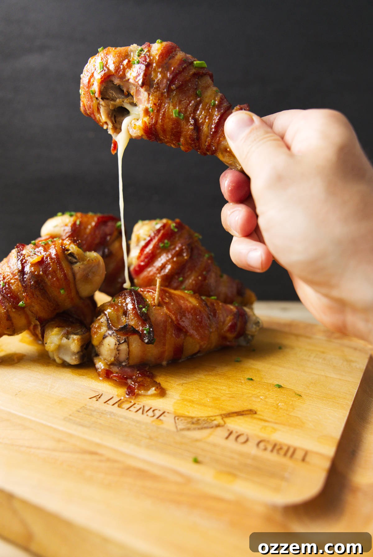 Smoky Traeger Stuffed Chicken Legs 6 Cheese oozing out of a Traeger smoked stuffed chicken leg.
