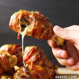 Smoky Traeger Stuffed Chicken Legs 7 Cheese oozing out of Traeger stuffed chicken leg after taking a bite.