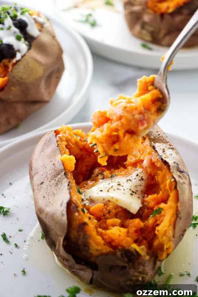 Air Fryer Sweet Potato Perfection 6 A fork piercing into the tender, steamy flesh of a perfectly air fryer baked sweet potato, highlighting its soft interior.