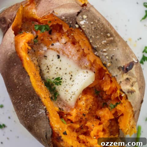 Air fryer baked sweet potato with butter, salt and pepper.