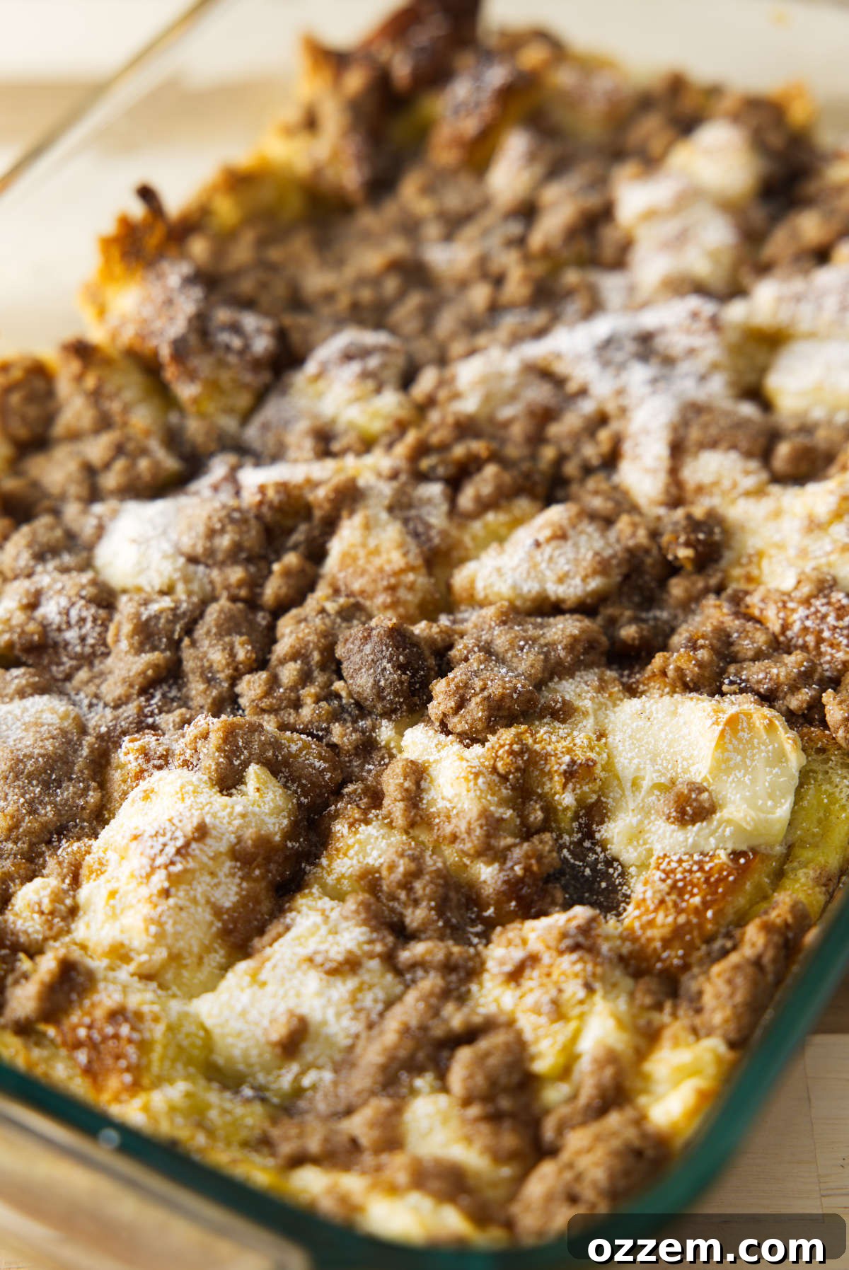 A large baking dish filled with golden-brown overnight French toast casserole, topped with a glistening cinnamon streusel. Perfect for a family breakfast or holiday brunch.