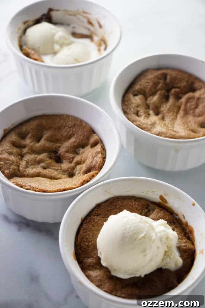 Four deep dish cookie bowls with ice cream, ready to be enjoyed.