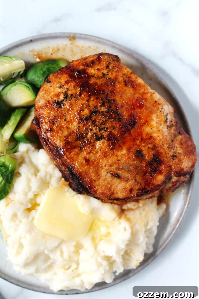Smoky Chipotle Air-Fried Pork Chops 5 Overhead photo of chipotle air fryer pork chops with creamy mashed potatoes and vibrant green Brussels sprouts, creating a balanced meal.