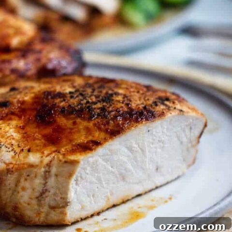 A chipotle air fryer pork chop sliced open to see the white meat.