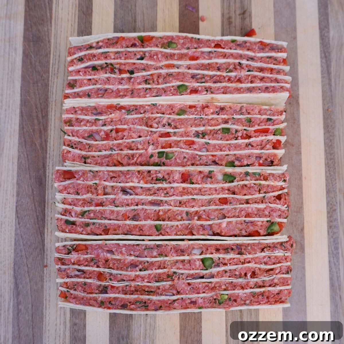Even layers of tortillas and beef mix stacked.