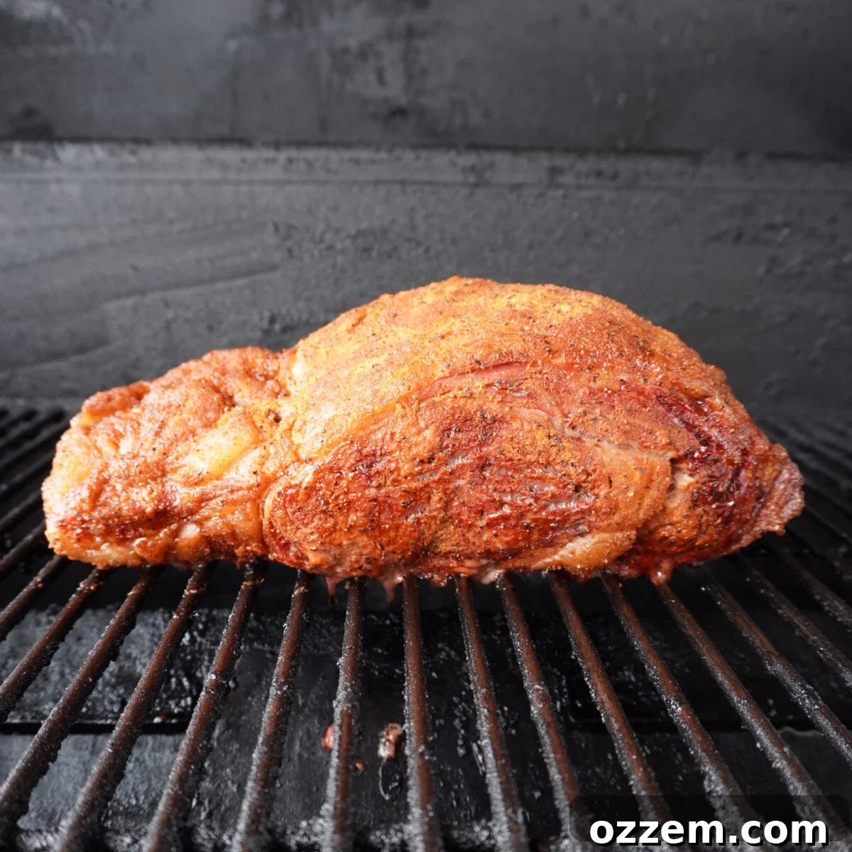 Gourmet Prime Rib Sliders 6 A seasoned prime rib roast gently smoking on a grill grate, surrounded by indirect heat for slow cooking.