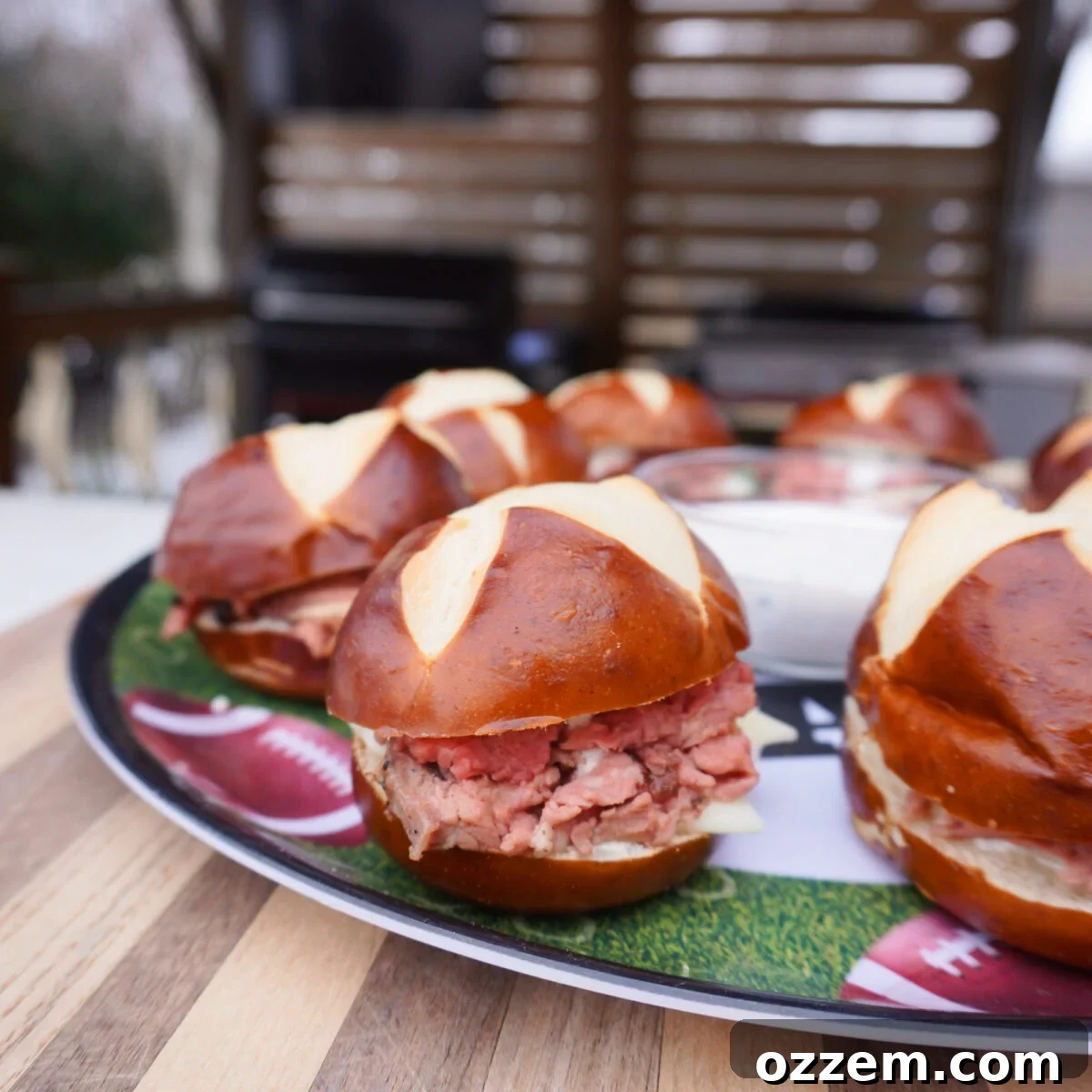 Gourmet Prime Rib Sliders 10 A vibrant platter showcasing an array of gourmet Grilled Prime Rib Sliders, featuring tender beef, melted cheese, and pretzel buns.