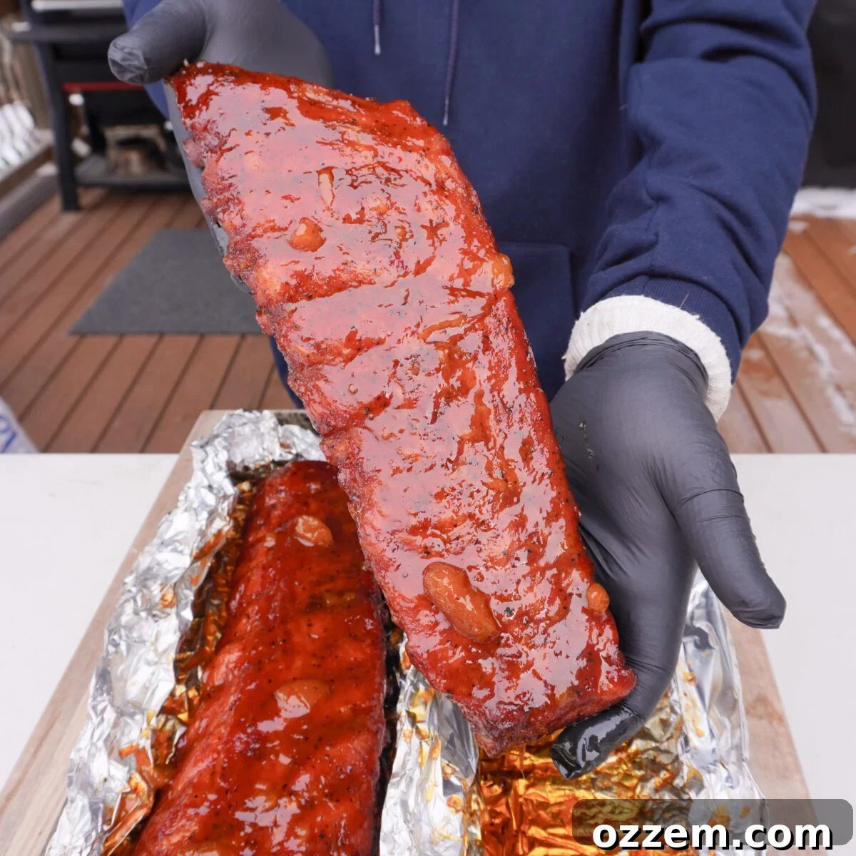 A stunning close-up of Peach Bourbon Smoked Ribs, glistening with glaze.