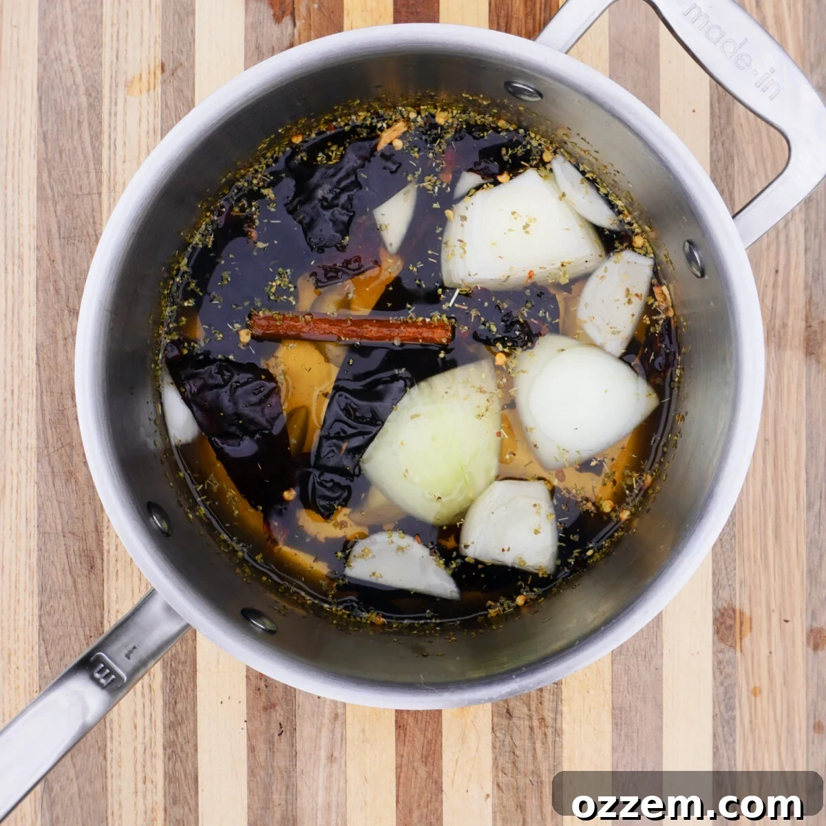 Adobo sauce ingredients simmering in a saucepan.