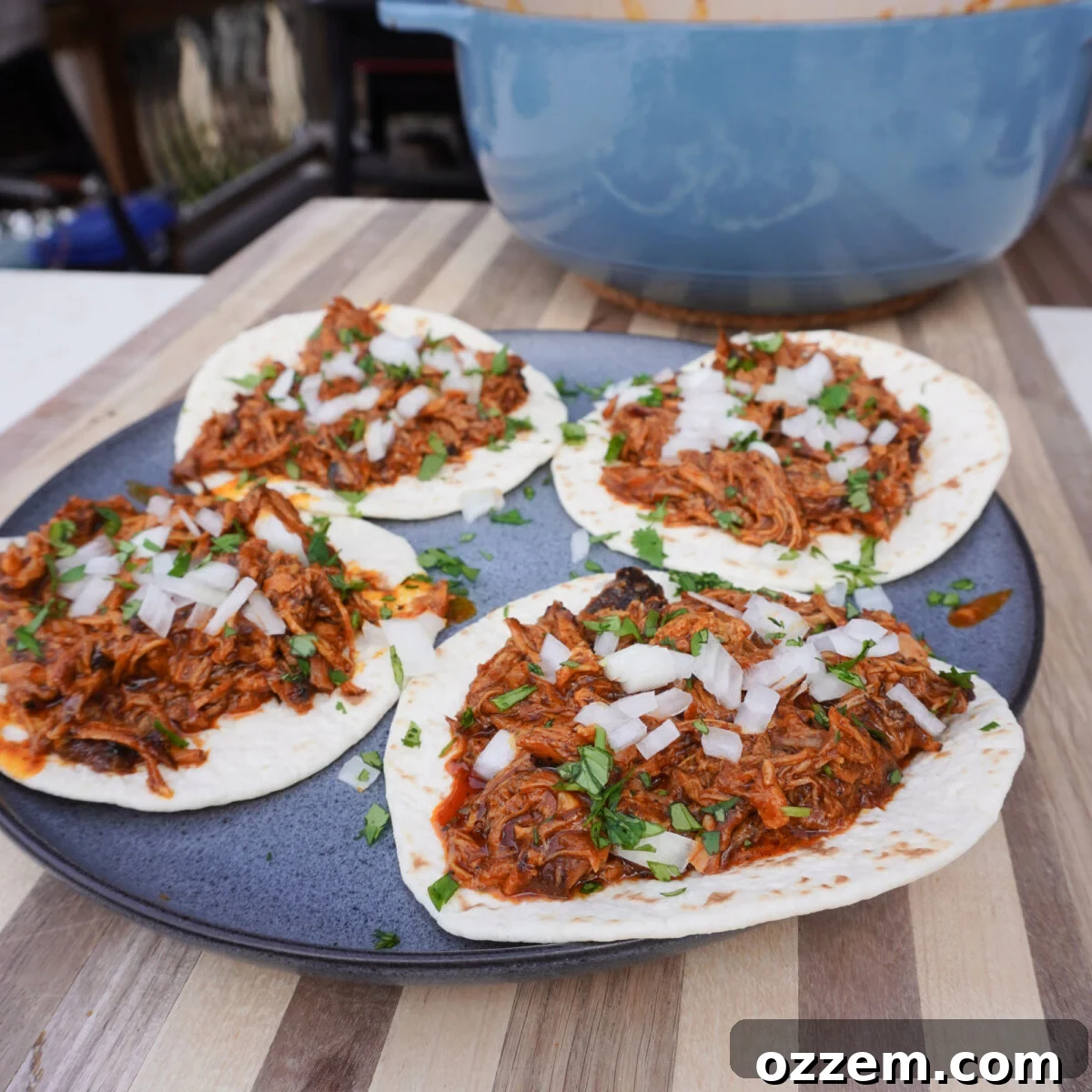 Grilled tacos al pastor plated with fresh garnishes.