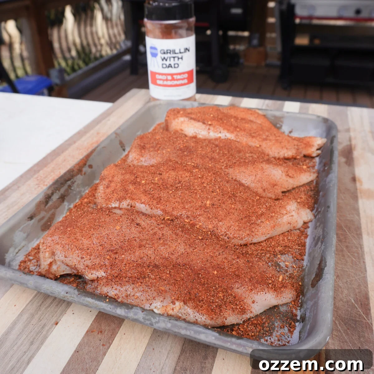 raw chicken breast seasoned with taco seasoning.