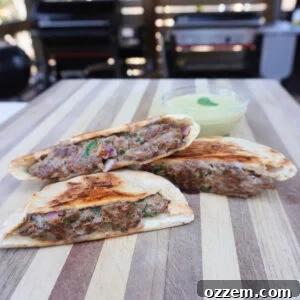 Grilled beef arayes on a cutting board, garnished with fresh cilantro.