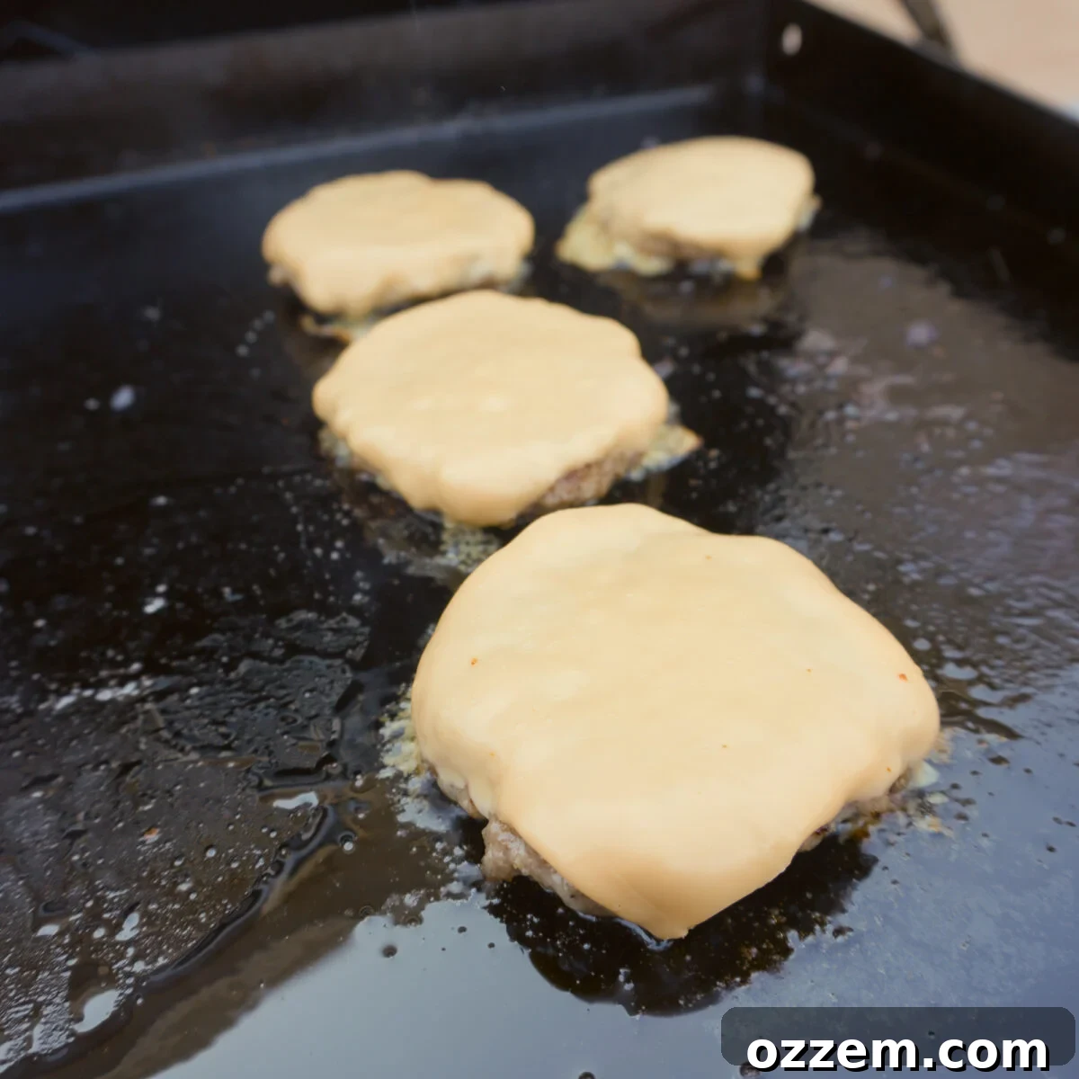 Homemade McGriddle sandwich patties topped with perfectly melted American cheese.