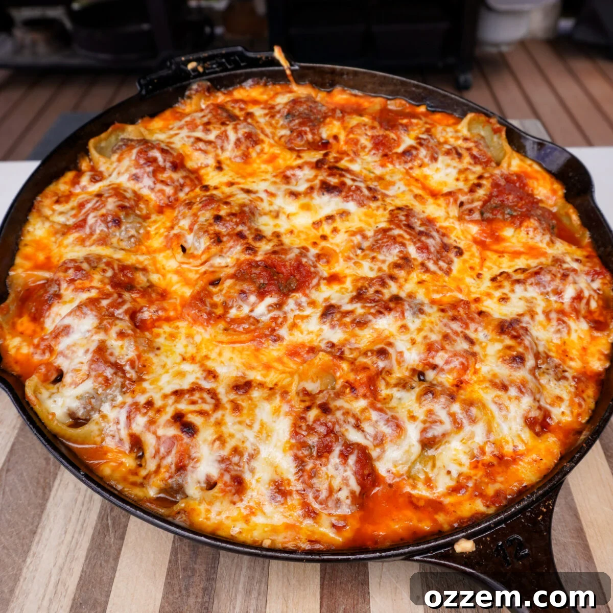 Smoked stuffed shells in a cast iron skillet.