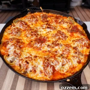 Smoked stuffed shells in a cast iron skillet.