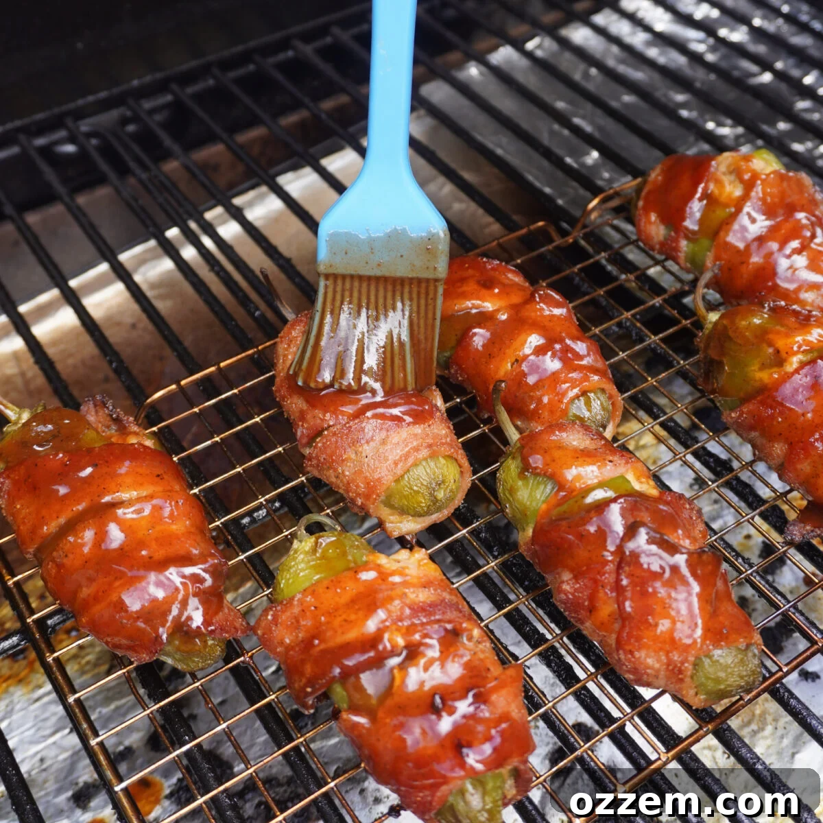 Pulled Pork-Stuffed Jalapeño Poppers: Smoky, Cheesy Bites 9 BBQ sauce brushed pulled pork jalapeno poppers on the grill.